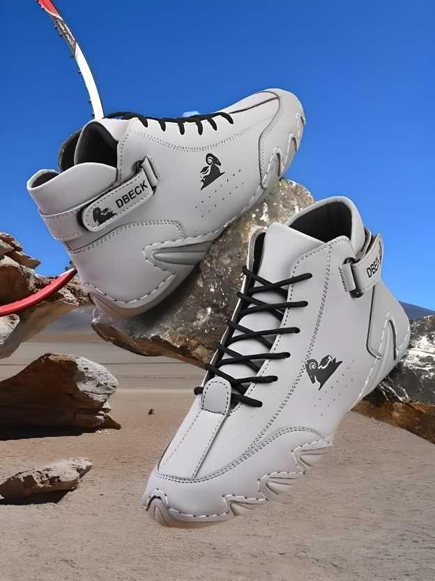 White DBECK high-top sneakers with black laces and logo, displayed outdoors on rocks