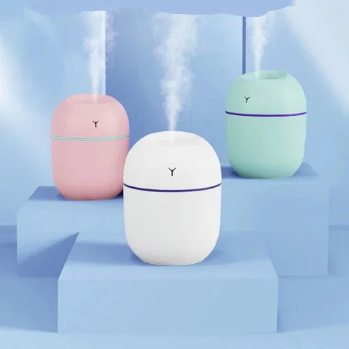 Colorful portable humidifiers emitting mist on blue display, home air moisture devices by PK